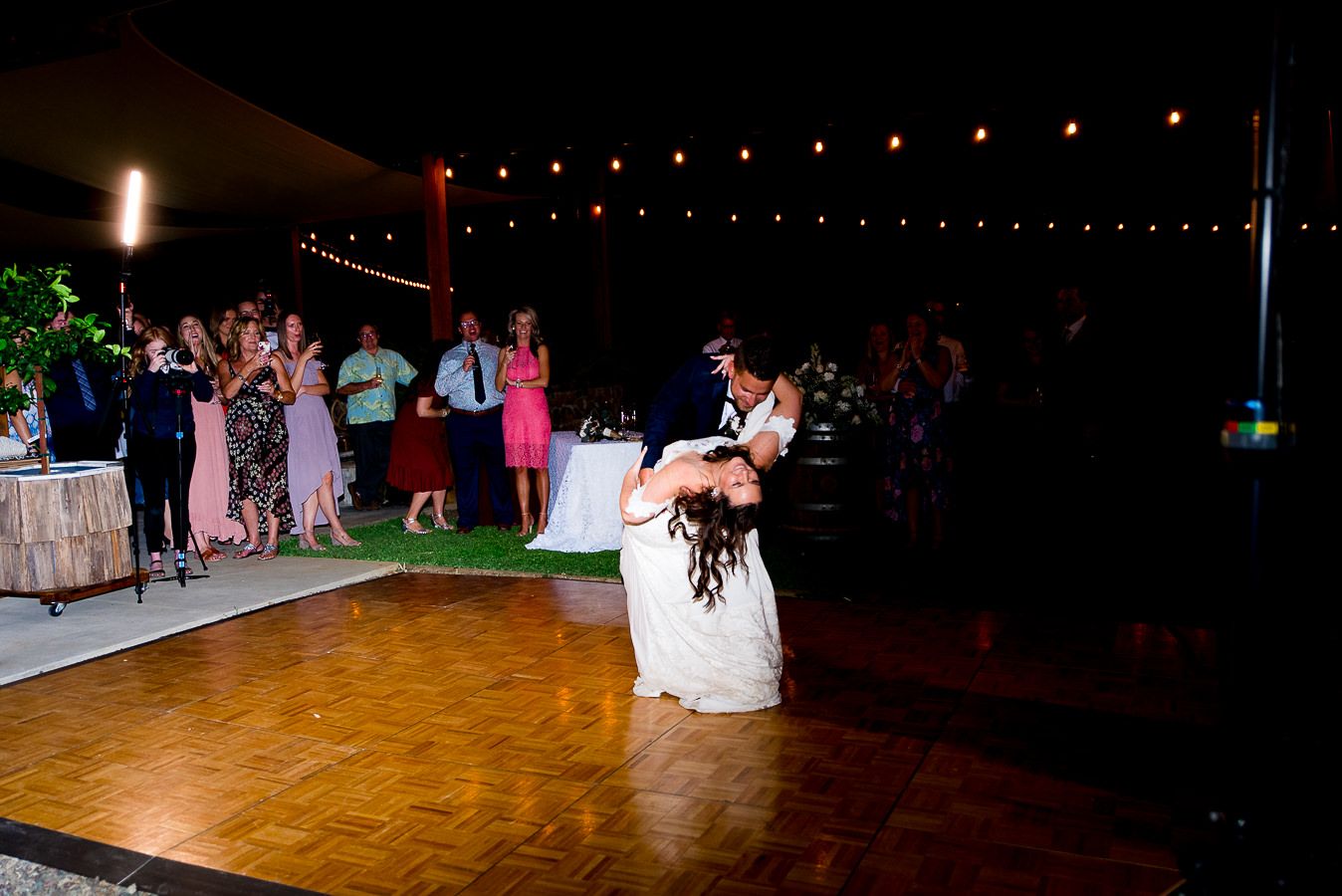 bride and groom dance and dip on reception floor