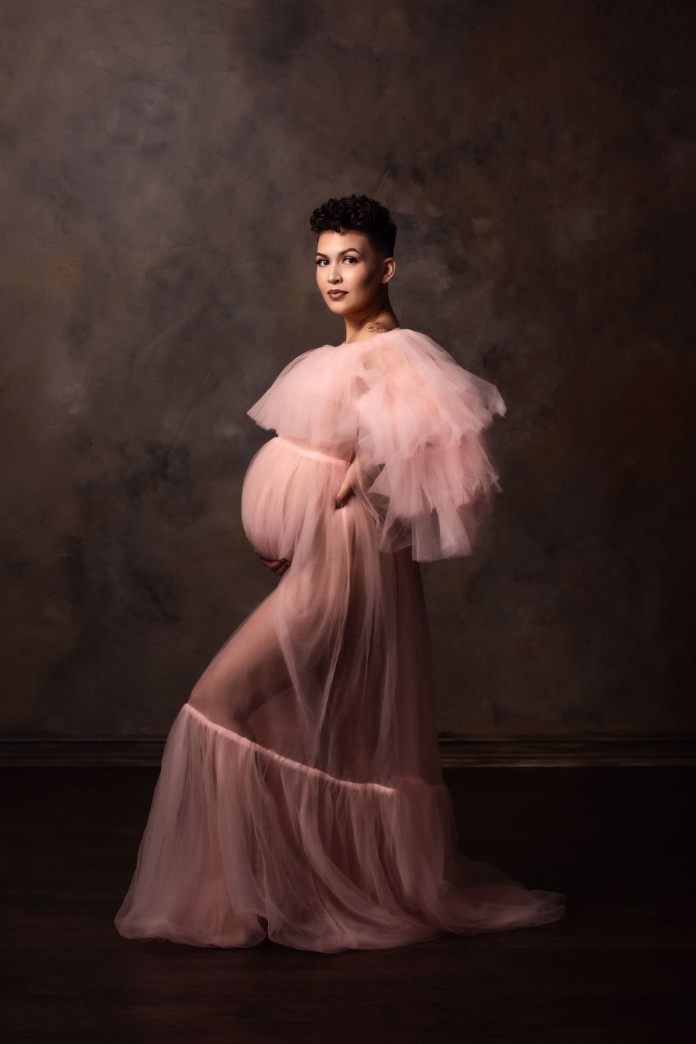 Fine art studio maternity portrait in a Mama Bump rental gown.
