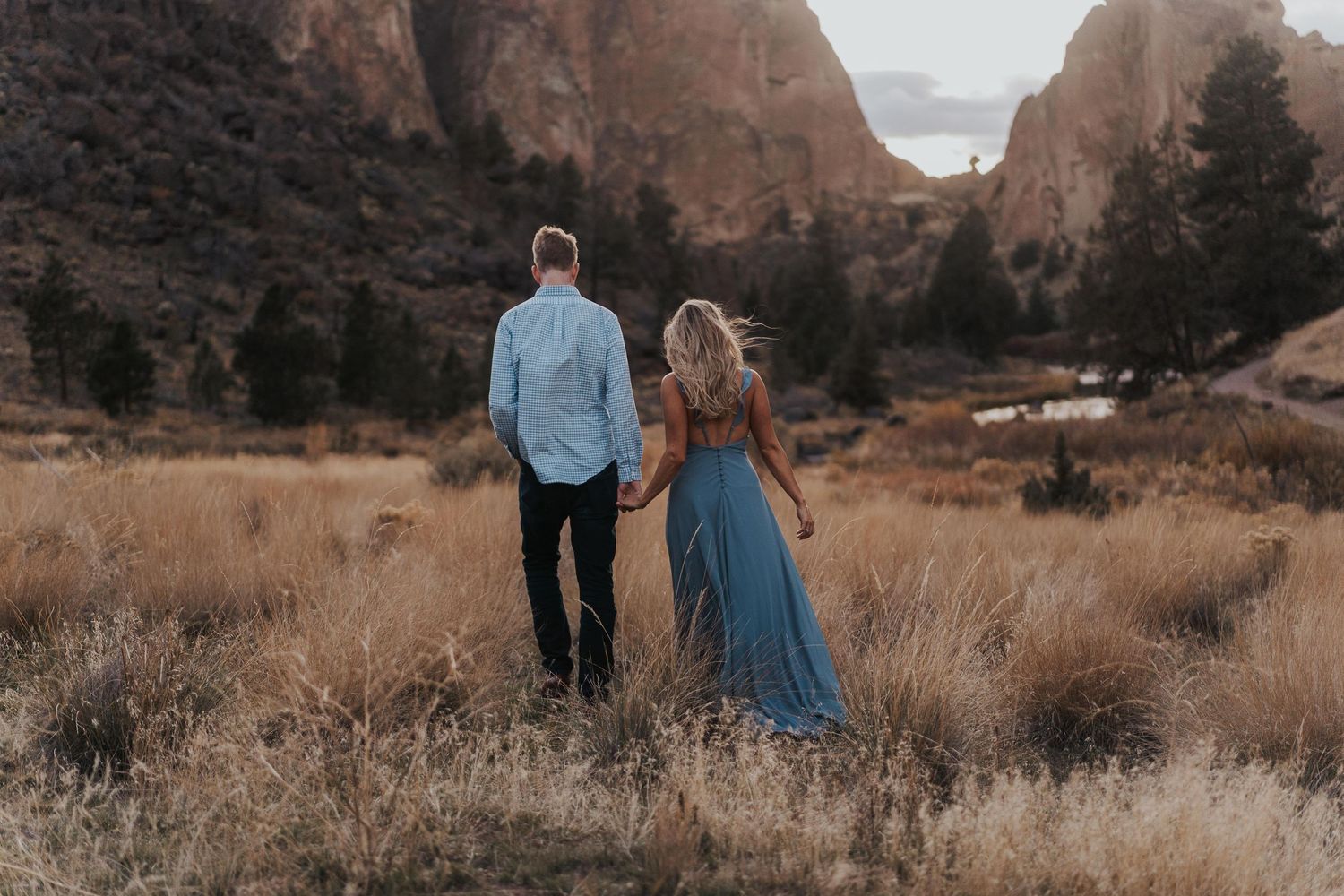 Photo by Kelsie Burke Photography of the couple walking hand in hand through Smith Rock State Park