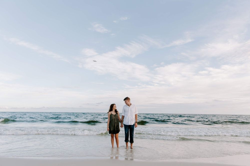 couple holding hands on the beach in Florida