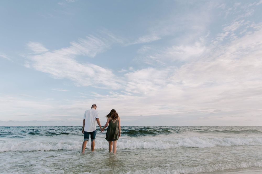 couple holding hands walking to the water on Okaloosa Island, Florida