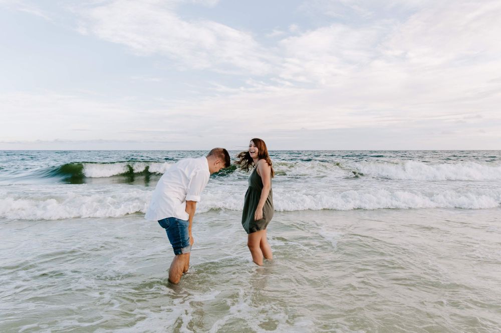 couple laughing in the water on a beach in Fort Walton Beach Florida
