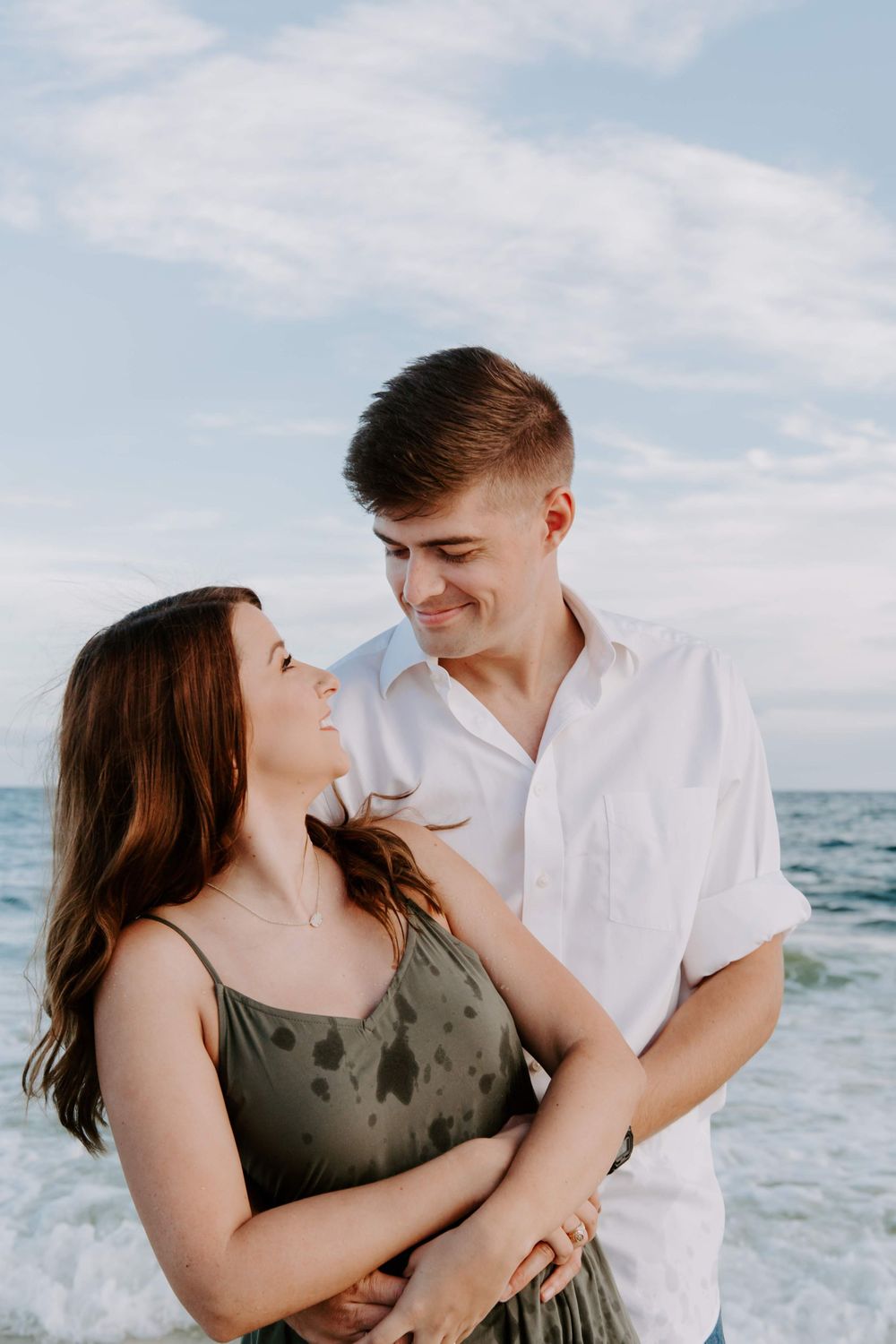 man wrapping his arms around his wife on Okaloosa Island
