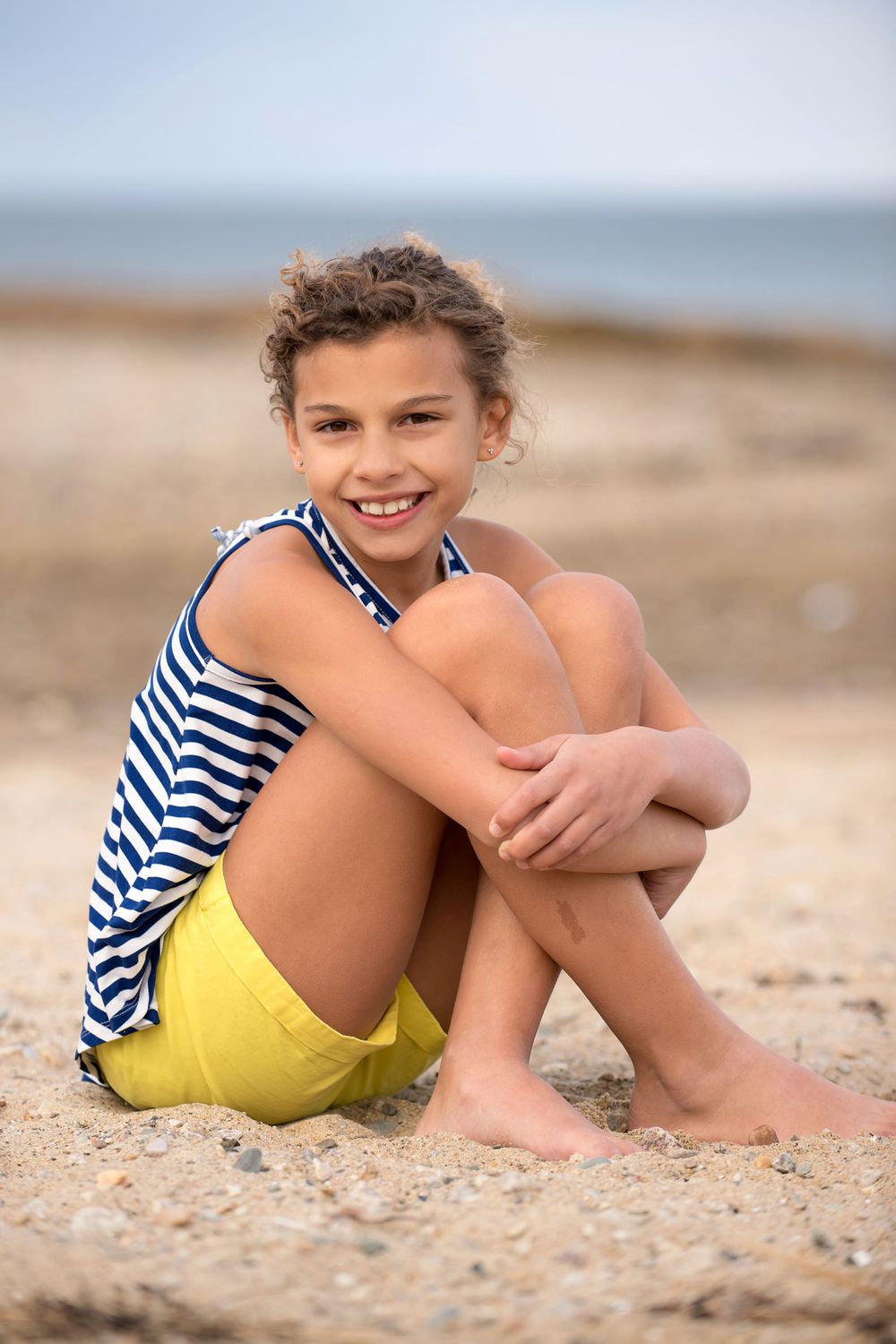 tween girl wearing shorts at the beach