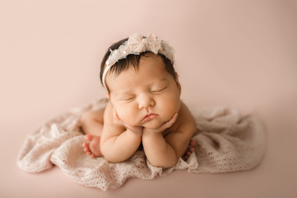 Froggy newborn baby pose in studio