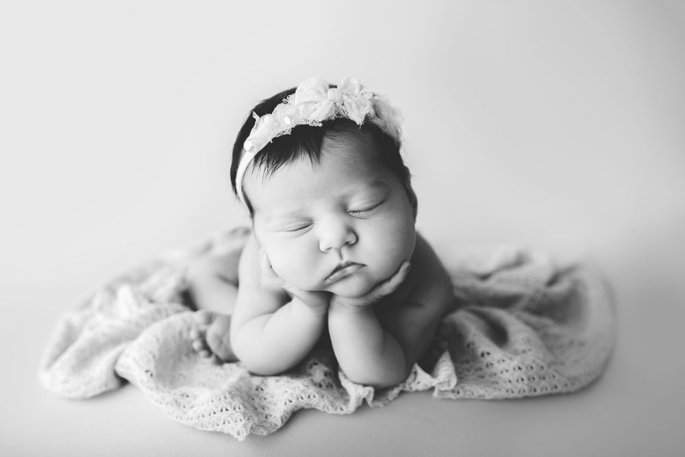 Froggy newborn baby pose in studio