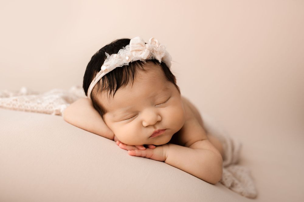 Froggy newborn baby pose in studio