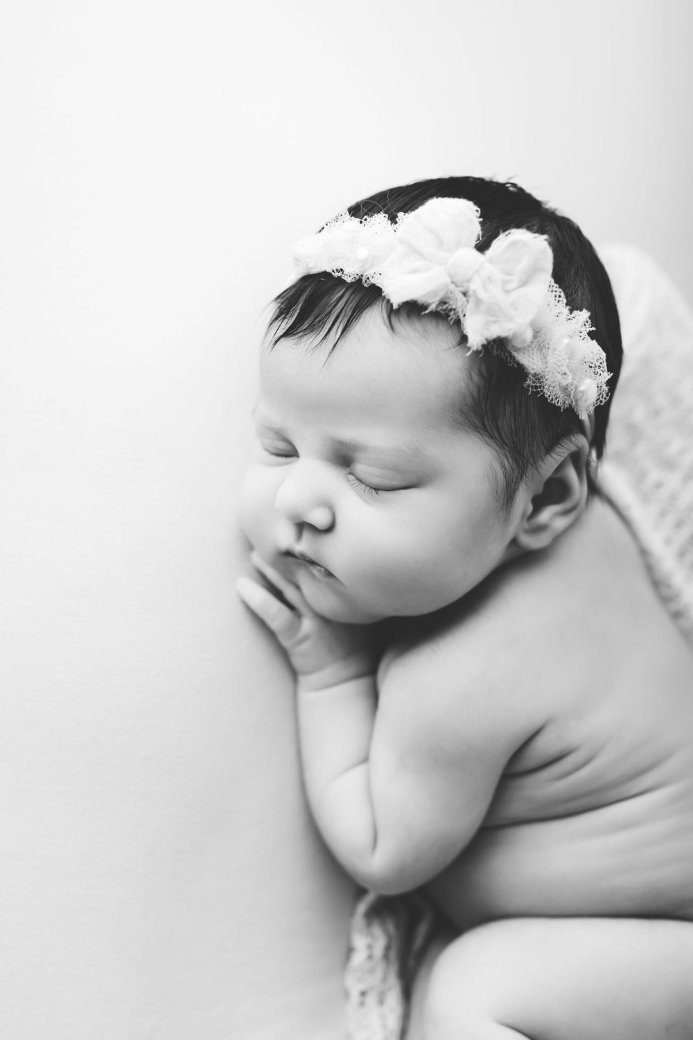 Froggy newborn baby pose in studio