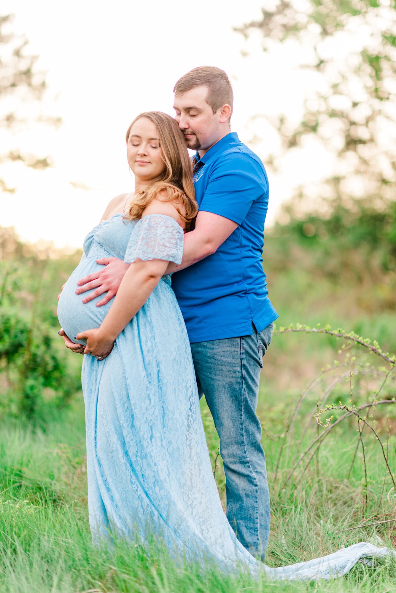 Maternity session with couple in field in golden hour sunlight at Moraine State Park, Pennsylvania