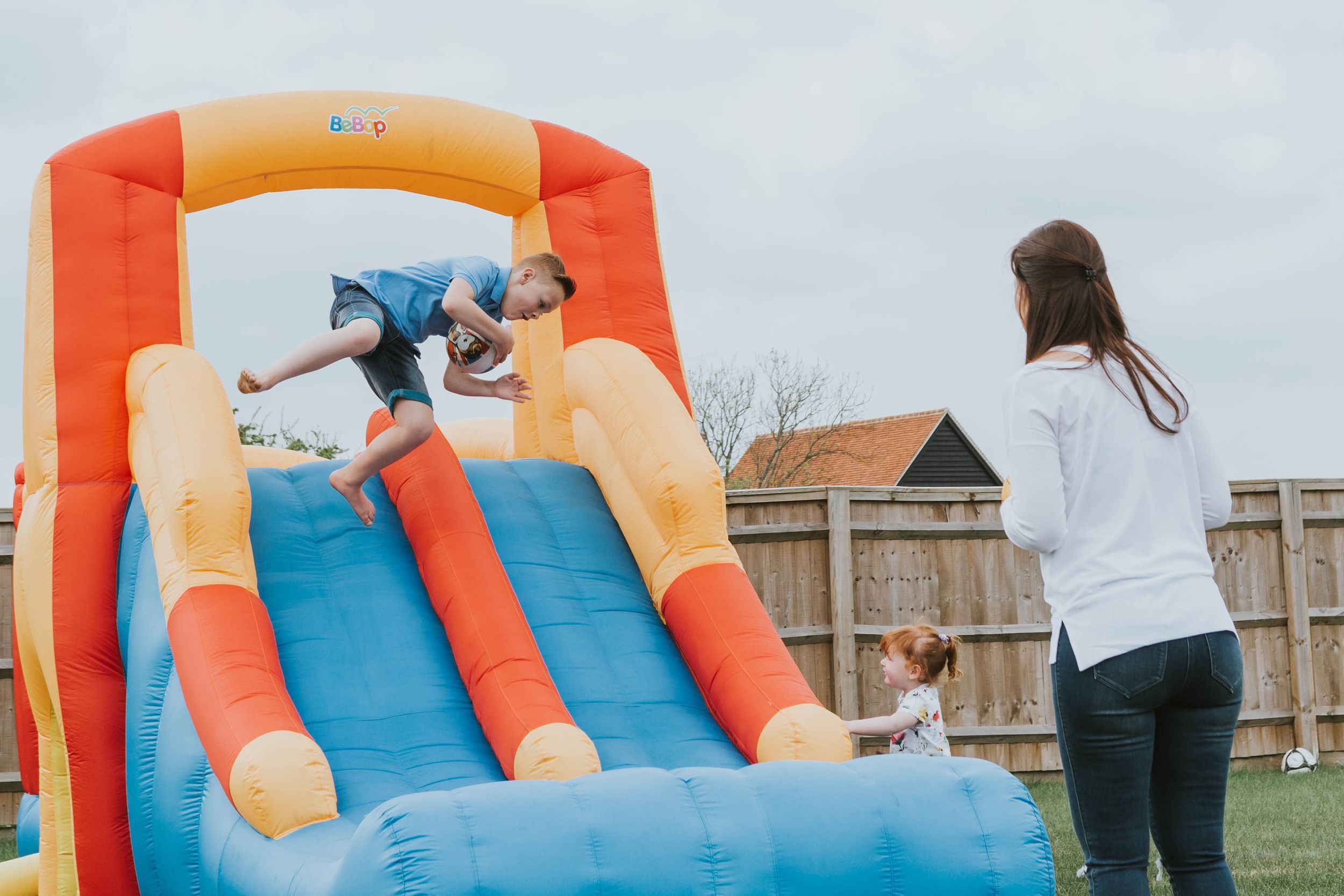 boy jumping on inflatable slide