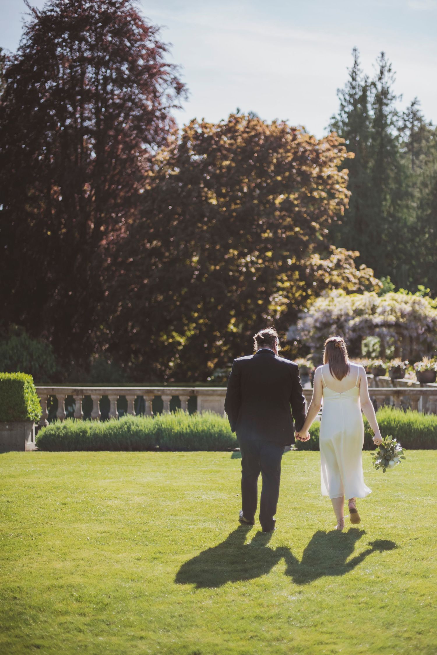 minimalist bride in satin dress and groom at Hatley Castle in Victoria british columbia.