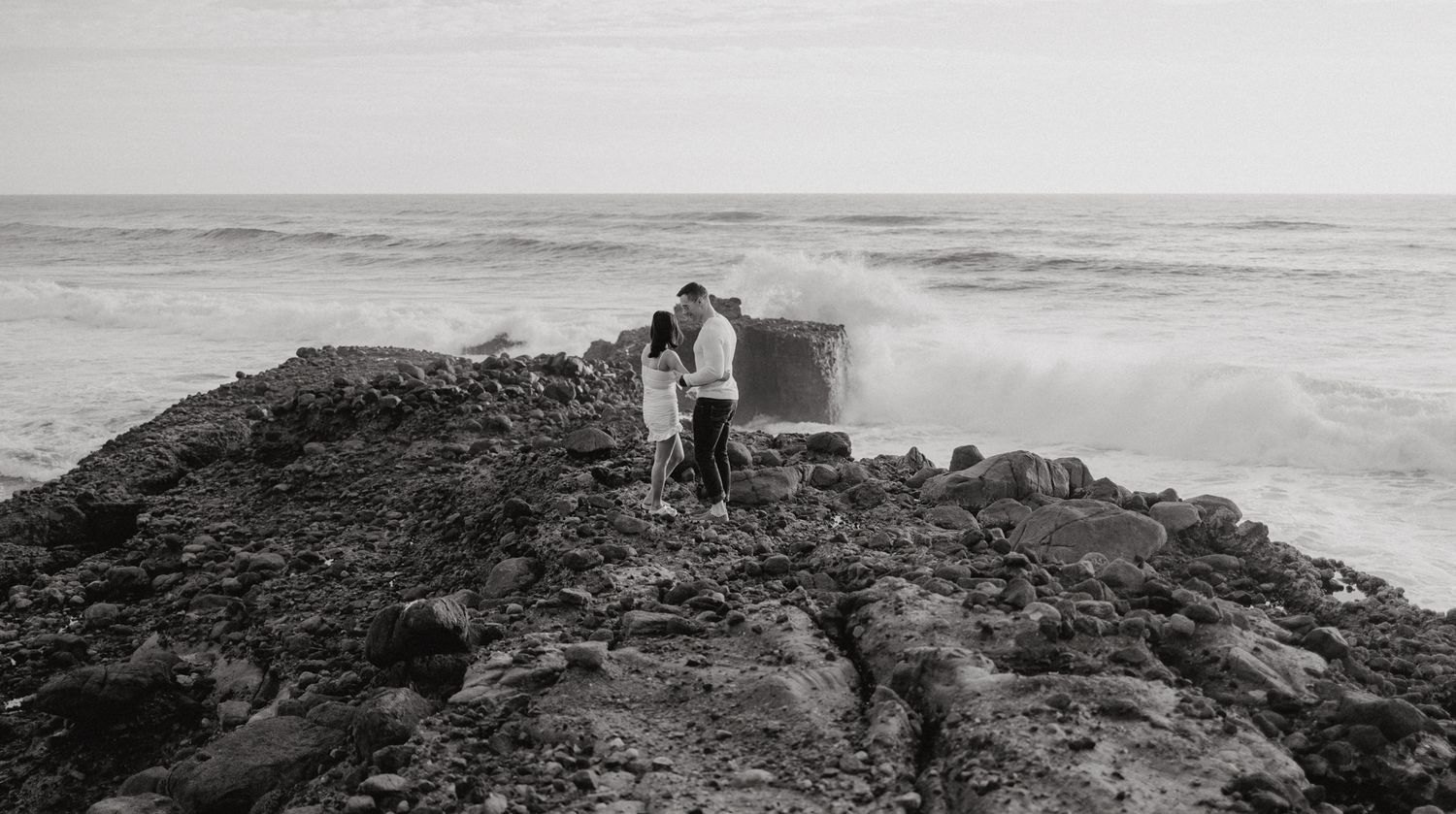 A couple on a cliff in their post-wedding photoshoot with Apertured Media-Auckland Wedding Photographer.