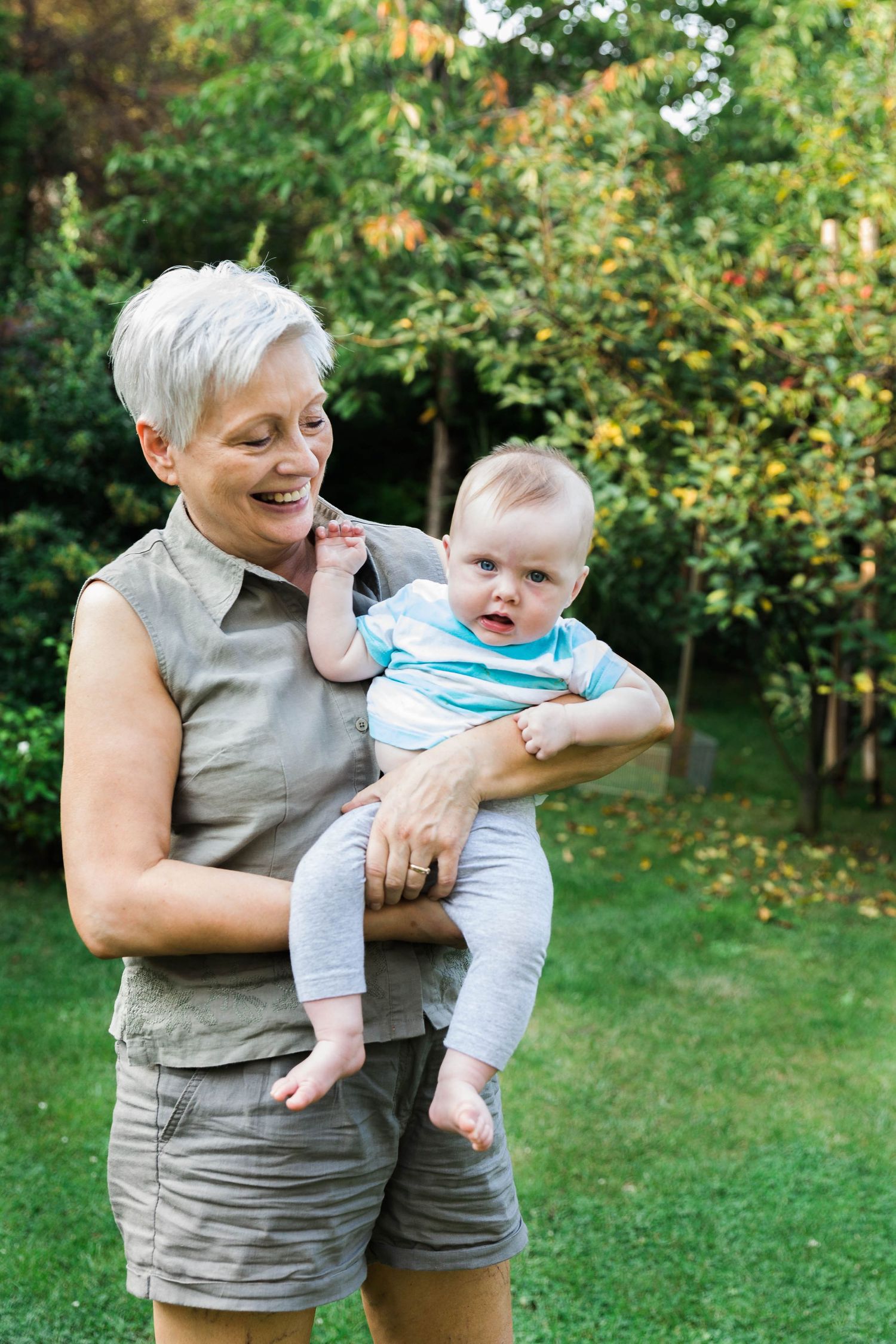 grandmother smiling holding little girl in arms