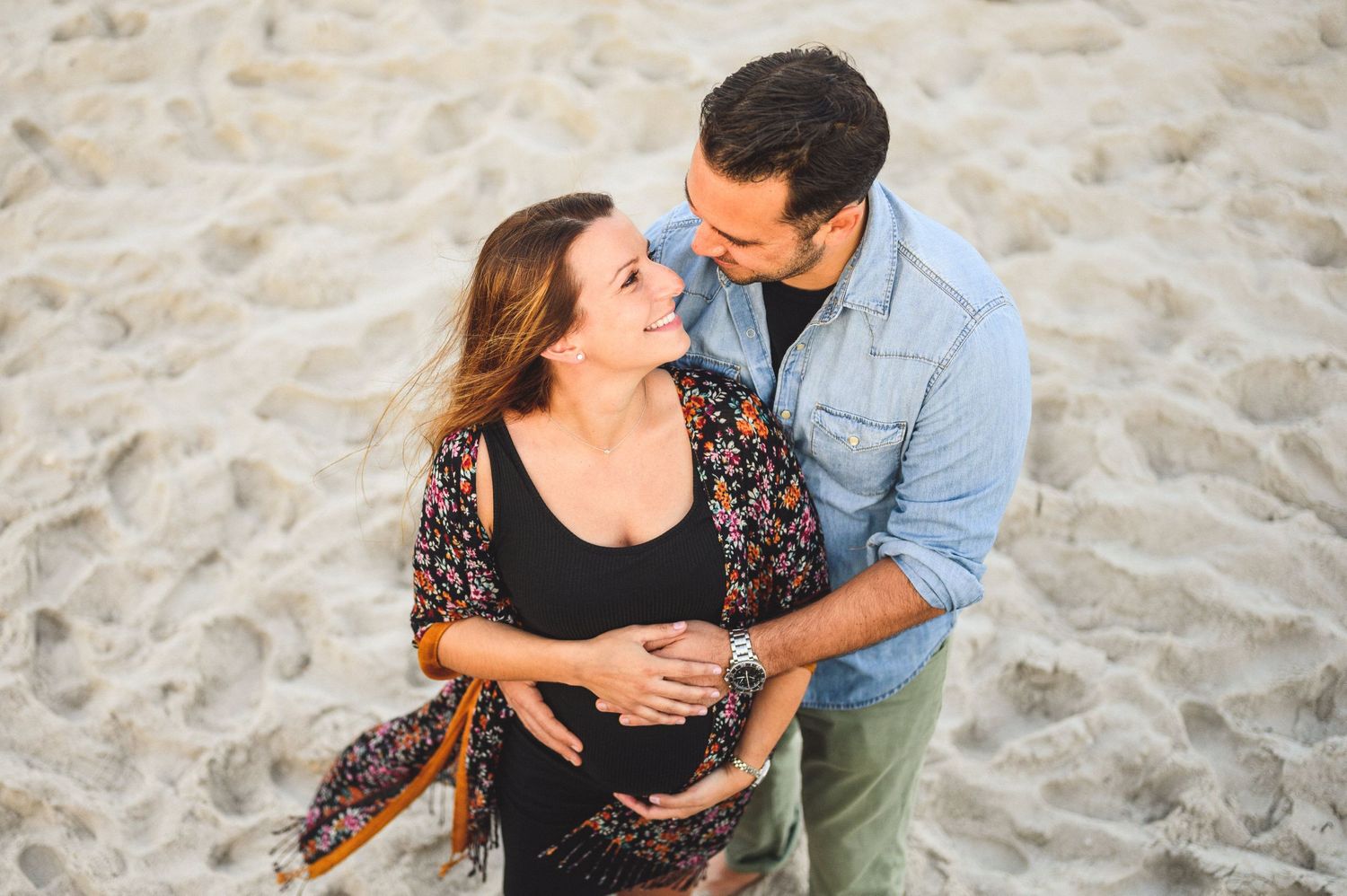 maternity couple on barnegat light beach during sunset