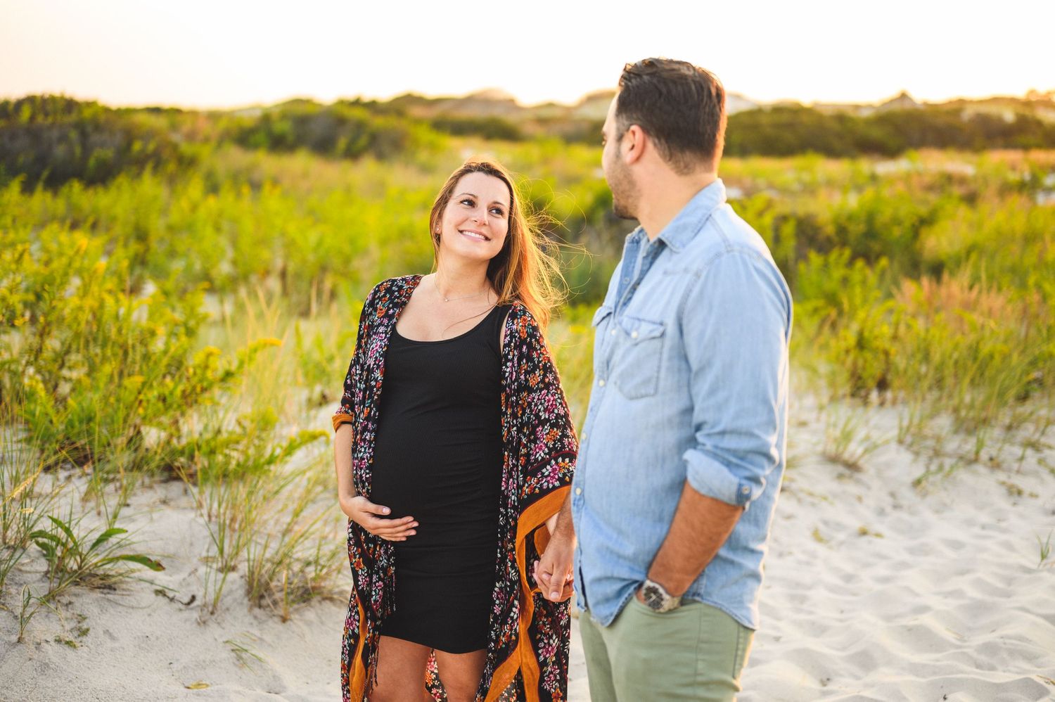 maternity couple on barnegat light beach during sunset