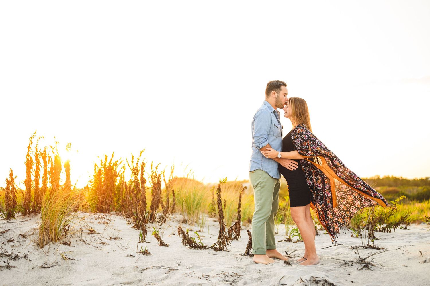 maternity couple on barnegat light beach during sunset