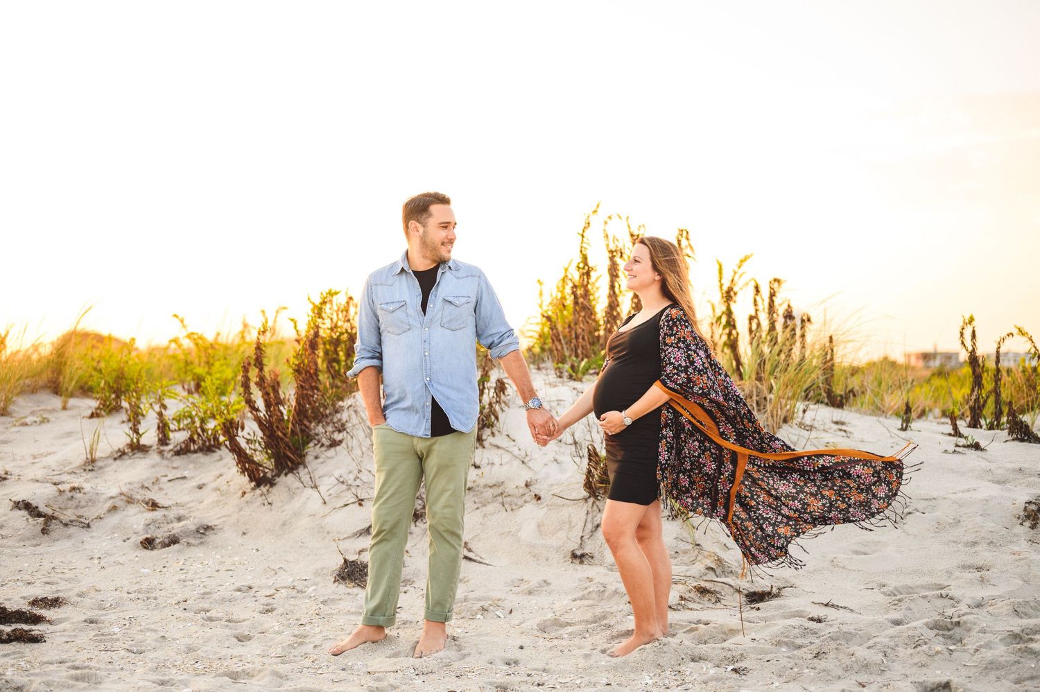 maternity couple on barnegat light beach during sunset