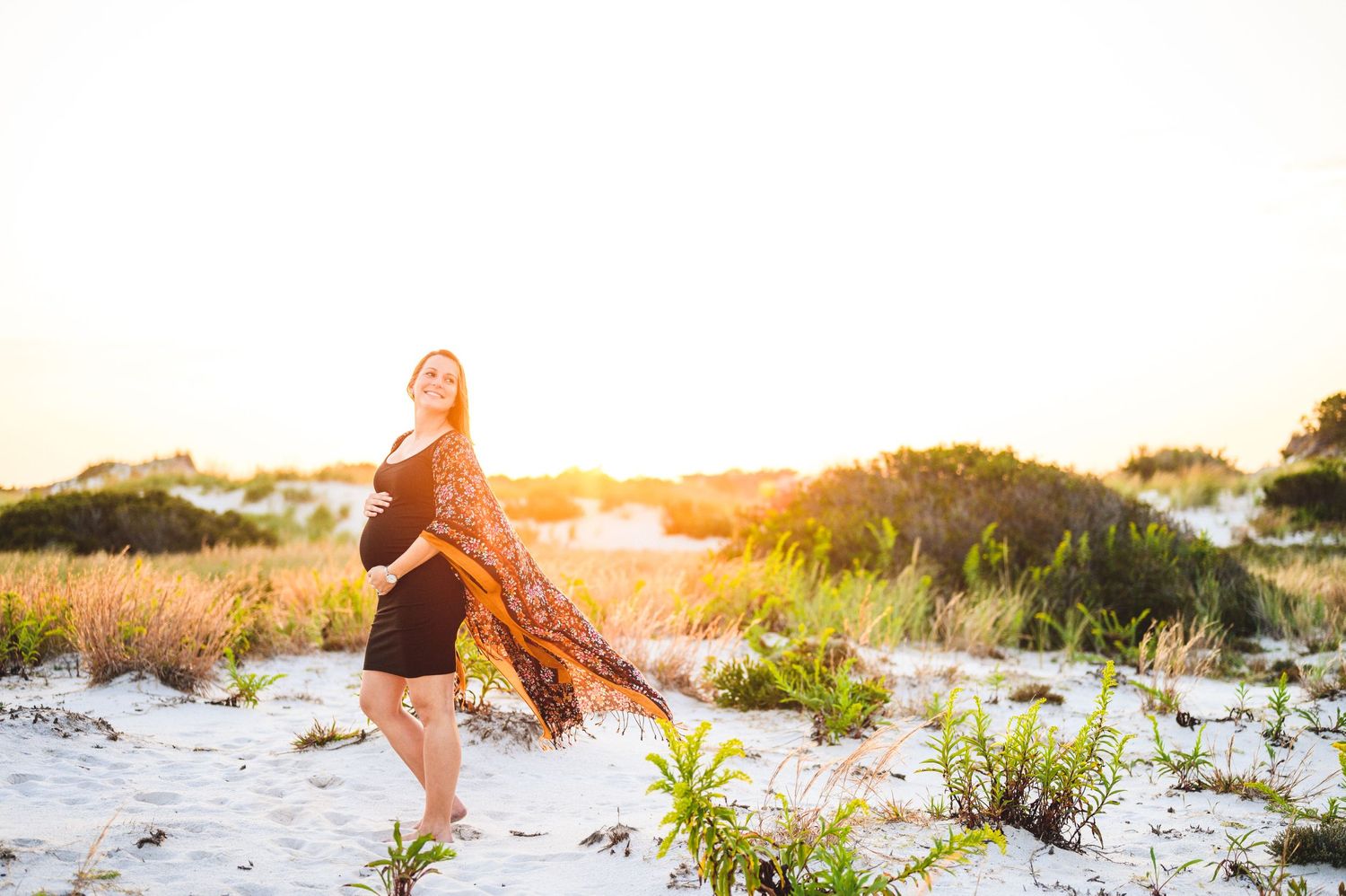 maternity couple on barnegat light beach during sunset