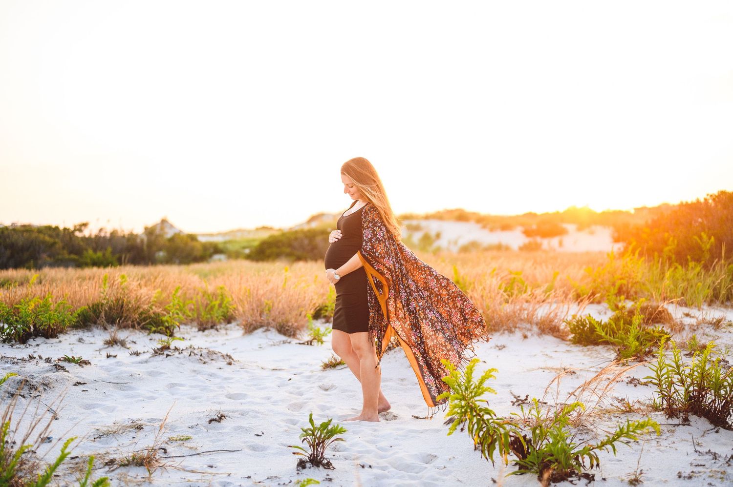 maternity couple on barnegat light beach during sunset