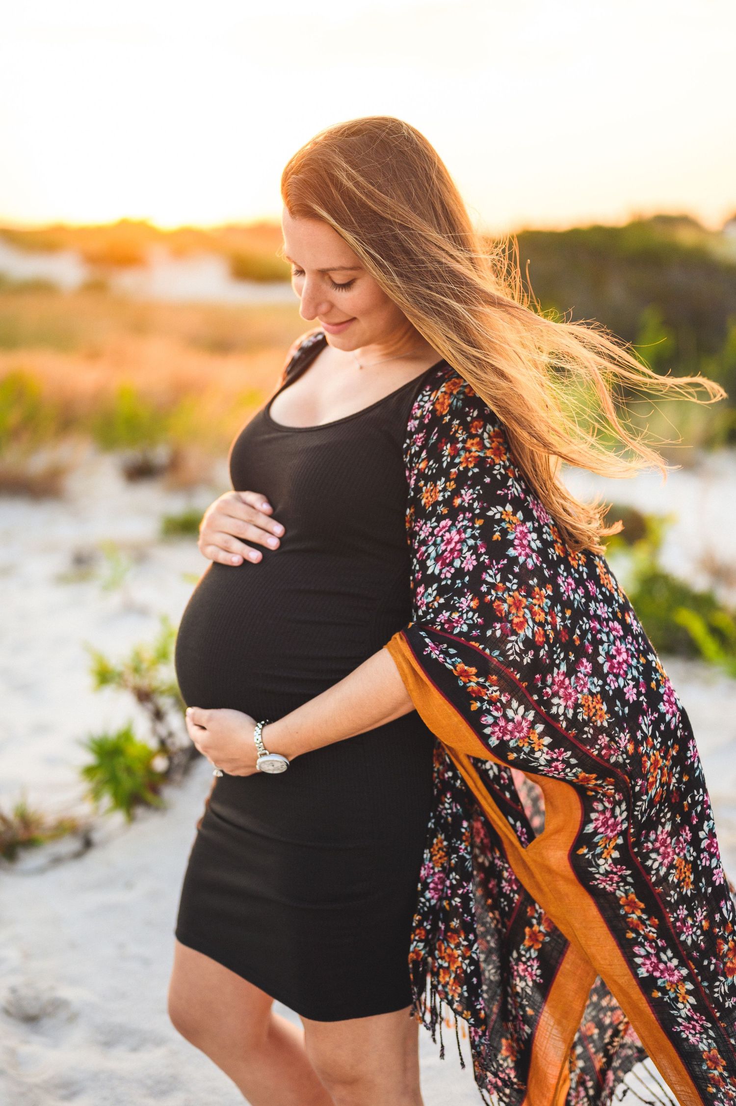 maternity couple on barnegat light beach during sunset