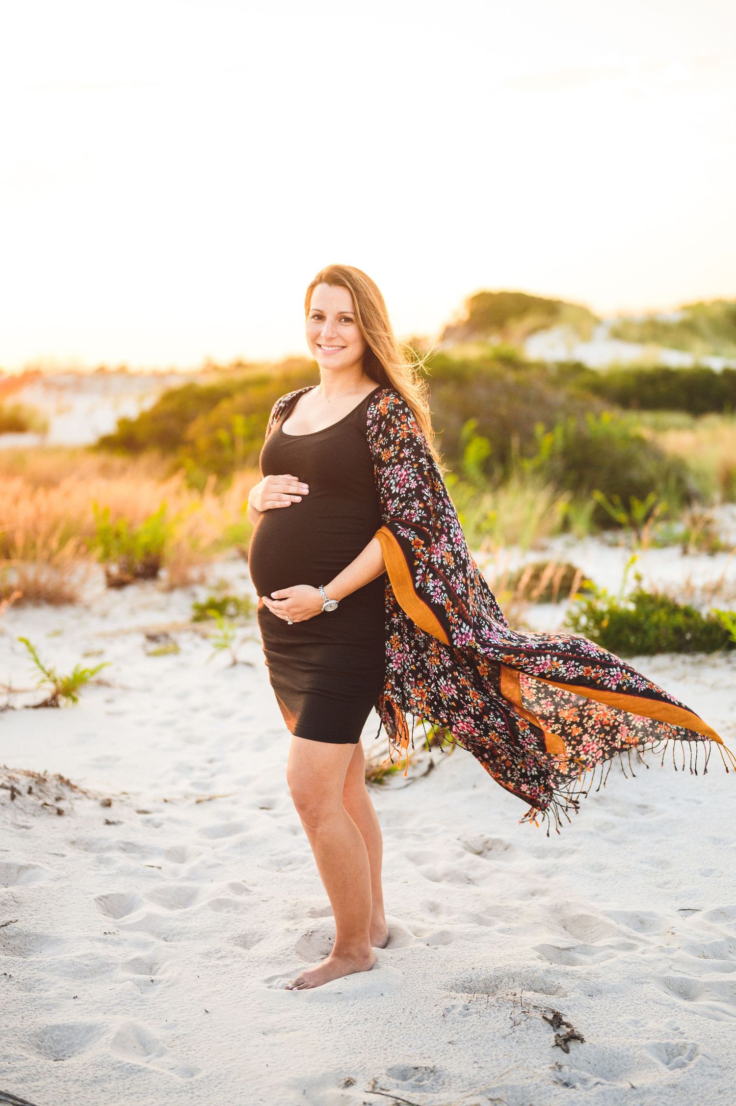 maternity couple on barnegat light beach during sunset