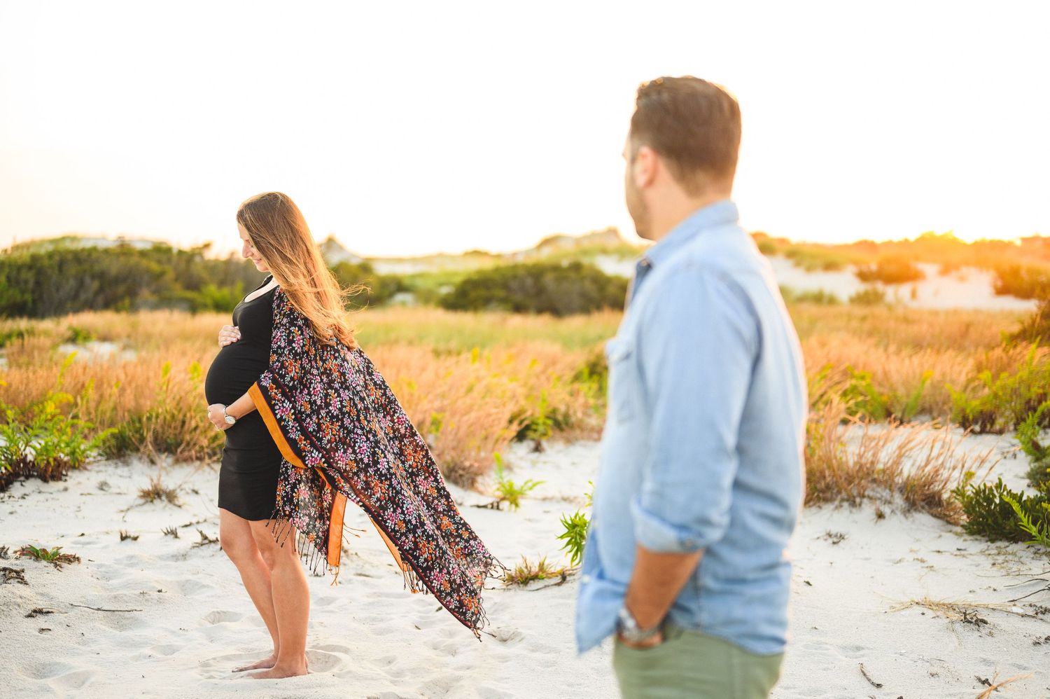 maternity couple on barnegat light beach during sunset