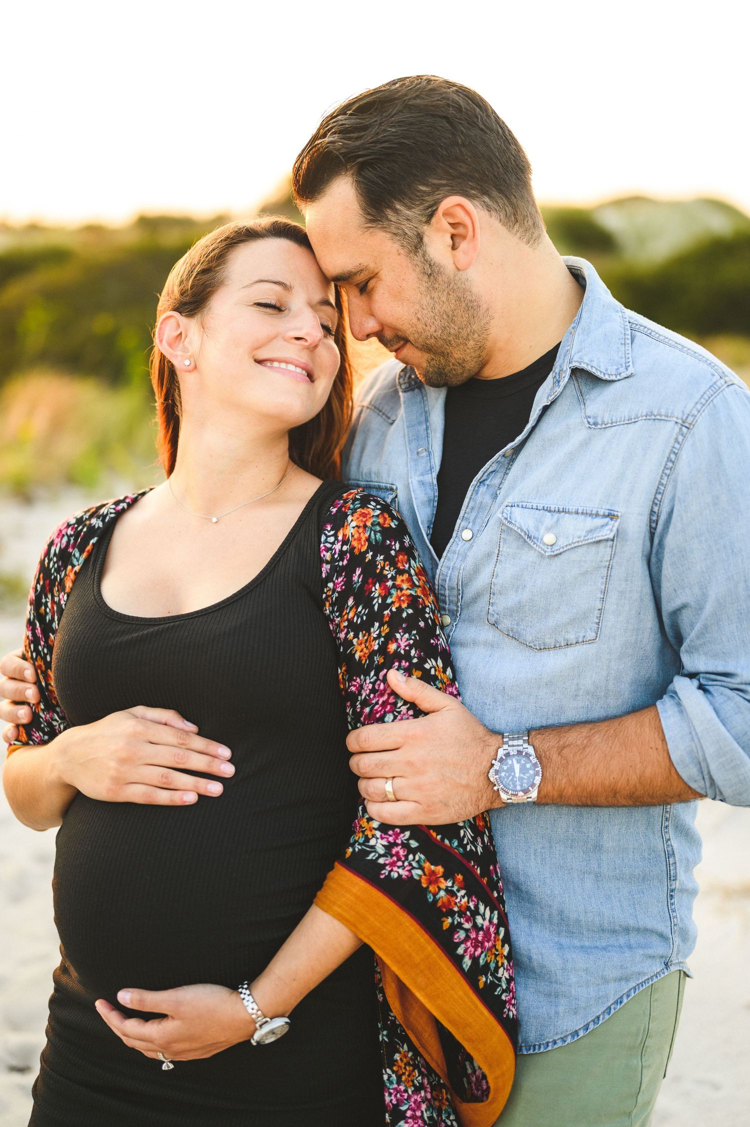maternity couple on barnegat light beach during sunset