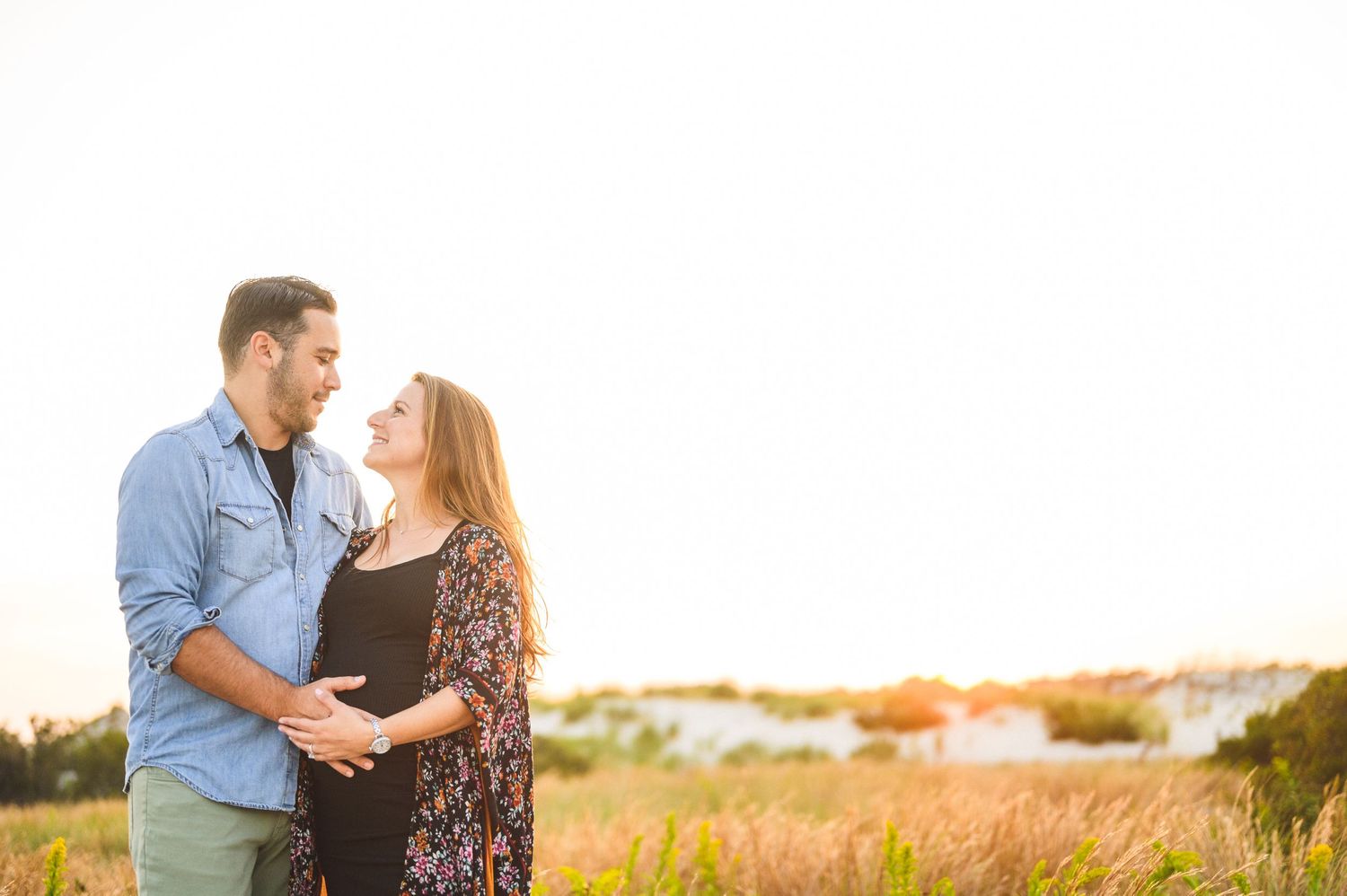 maternity couple on barnegat light beach during sunset