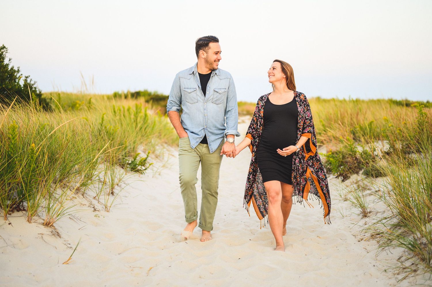 maternity couple on barnegat light beach during sunset