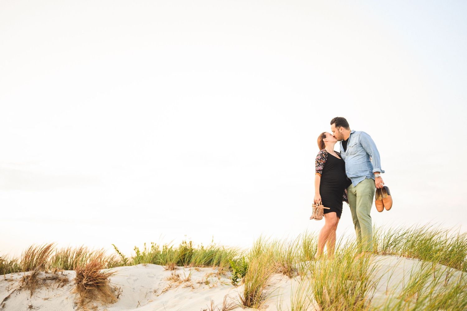 maternity couple on barnegat light beach during sunset