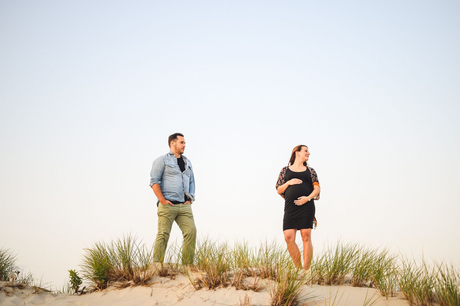 maternity couple on barnegat light beach during sunset