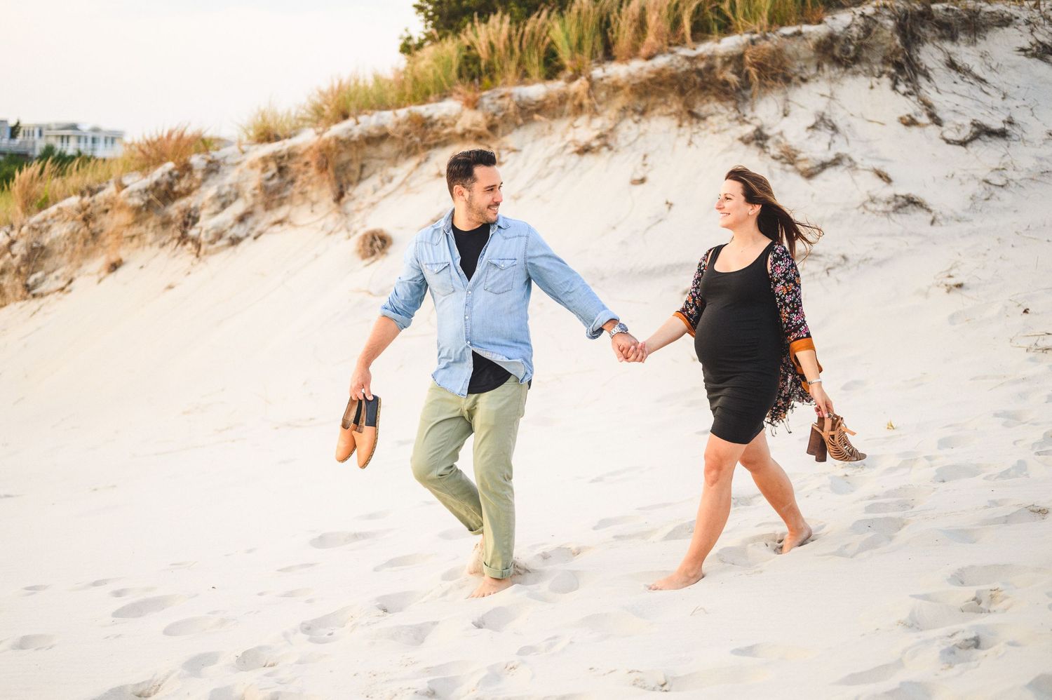 maternity couple on barnegat light beach during sunset