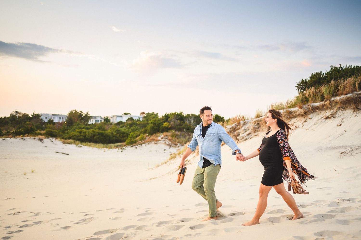maternity couple on barnegat light beach during sunset