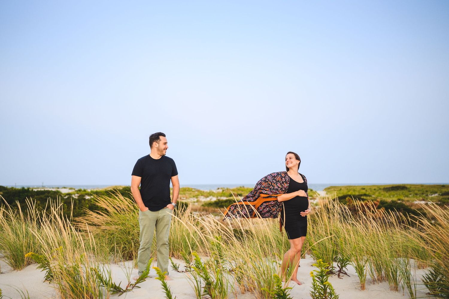 maternity couple on barnegat light beach during sunset