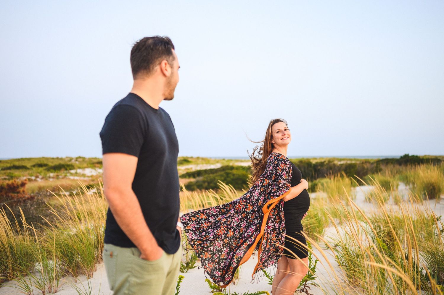 maternity couple on barnegat light beach during sunset