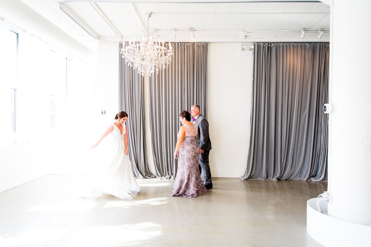 bride at Room 1520 wedding in Chicago sees her parents for the first look on wedding day