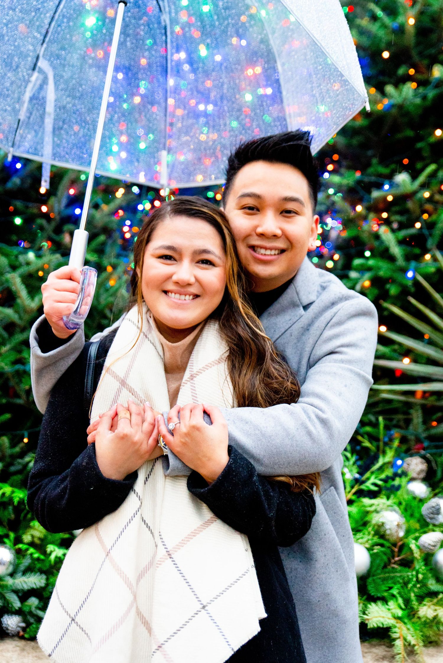 couple hugging under umbrella on rainy day in Chicago Millennium Park