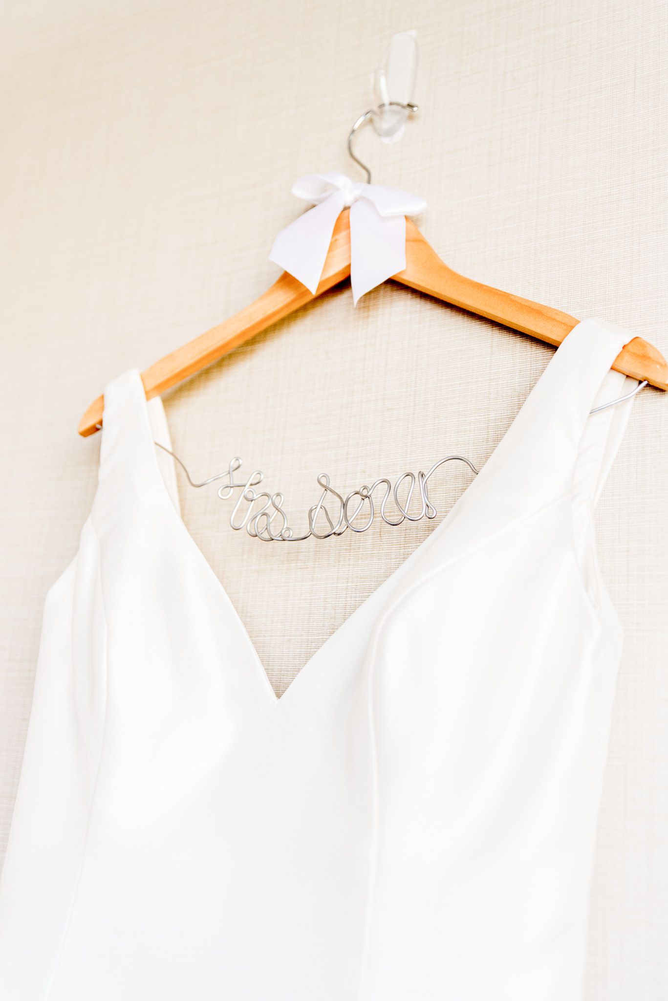 wired name hanger with white bow displays chicago bride wedding dress