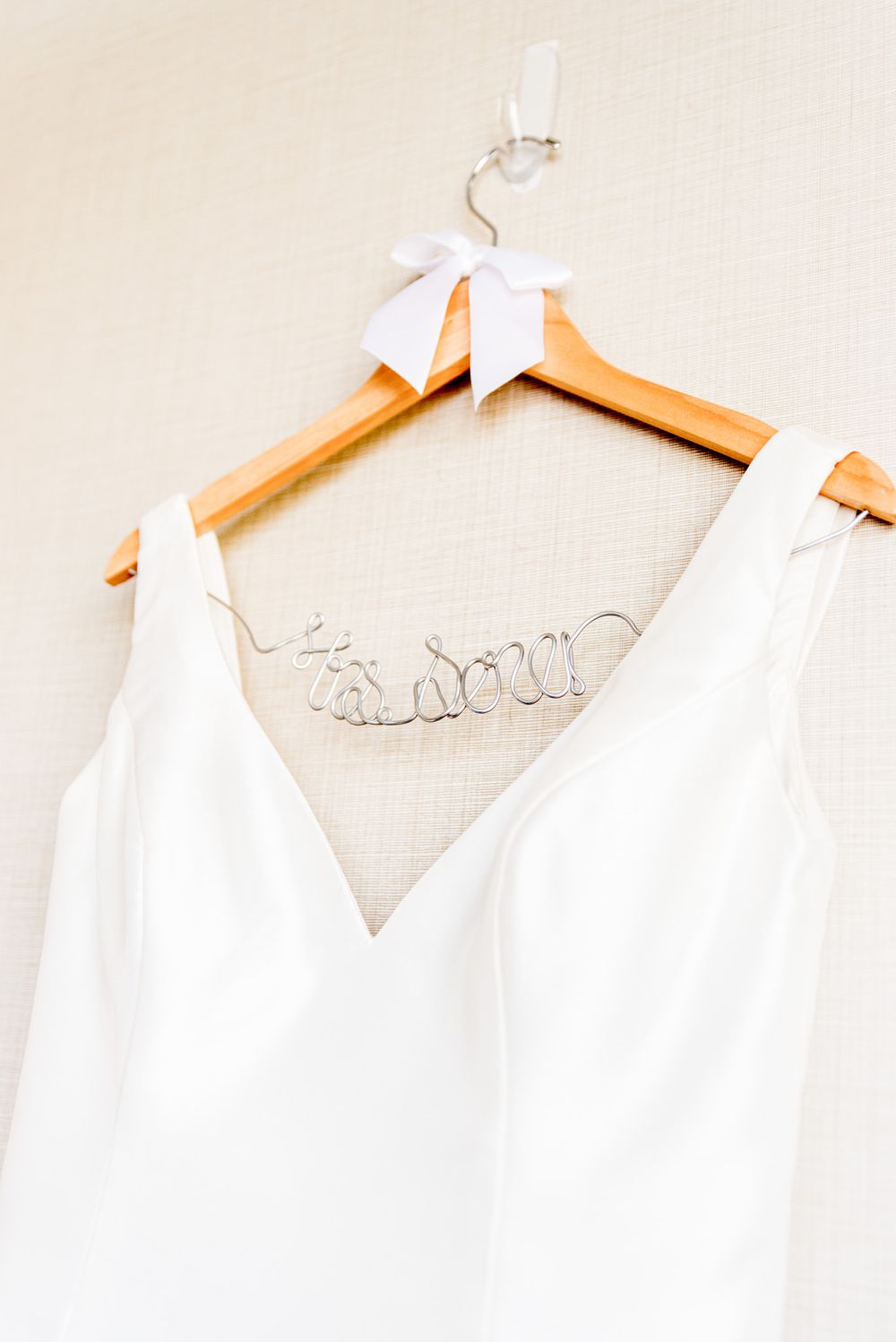 wired name hanger with white bow displays chicago bride wedding dress