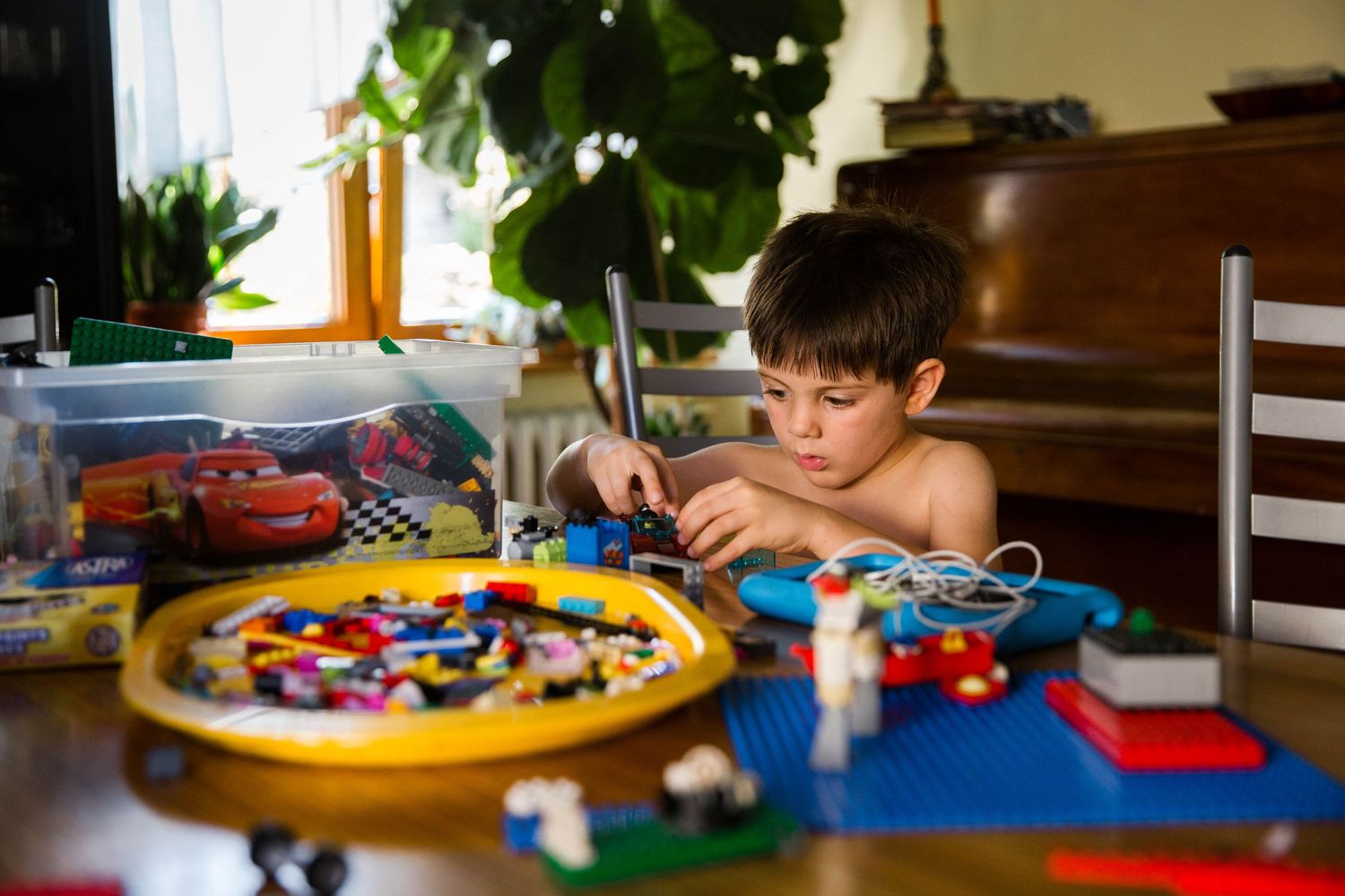little boy playing lego bricks