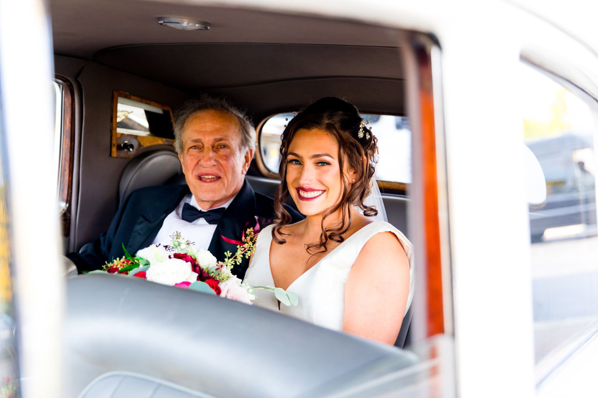 bride and father smile in bentley on fall chicago wedding day
