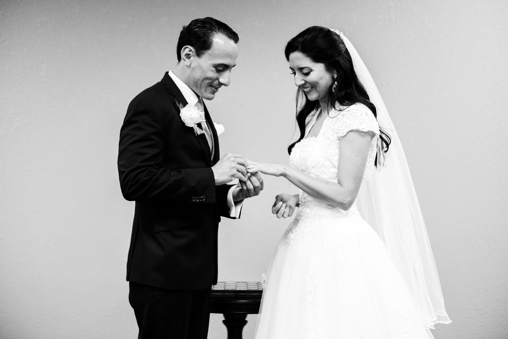 Groom puts ring on bride's finger in Hudson Valley wedding ceremony