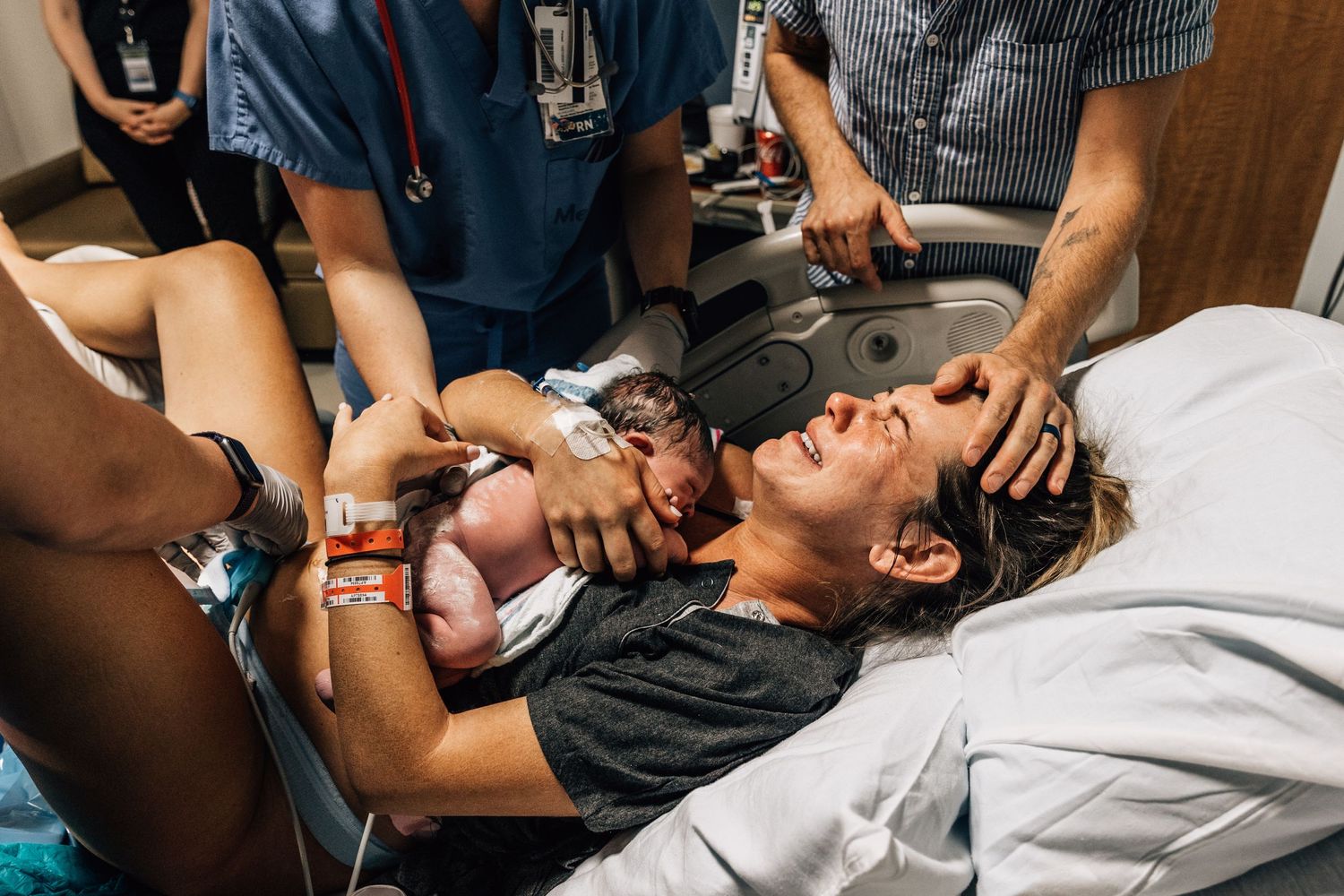 First time mom cradles her baby and cries