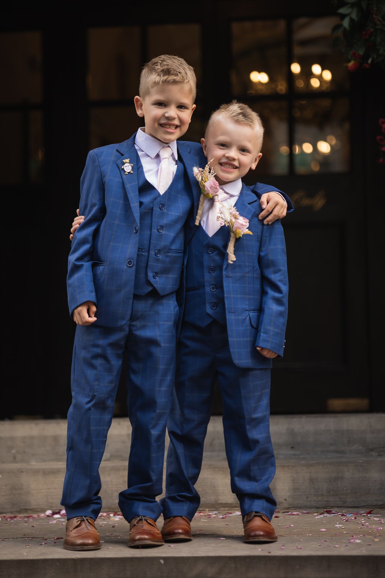 Page boys standing at the top of the steps at Chelsea Old Town Hall, London Registry office