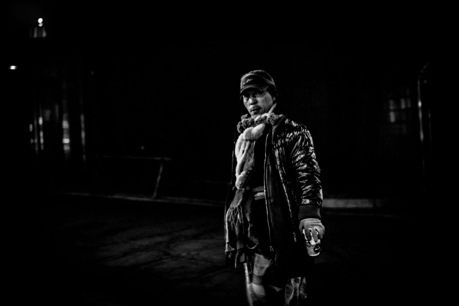 Black and white photo men walking with coffee at night in street of Soul South Korea