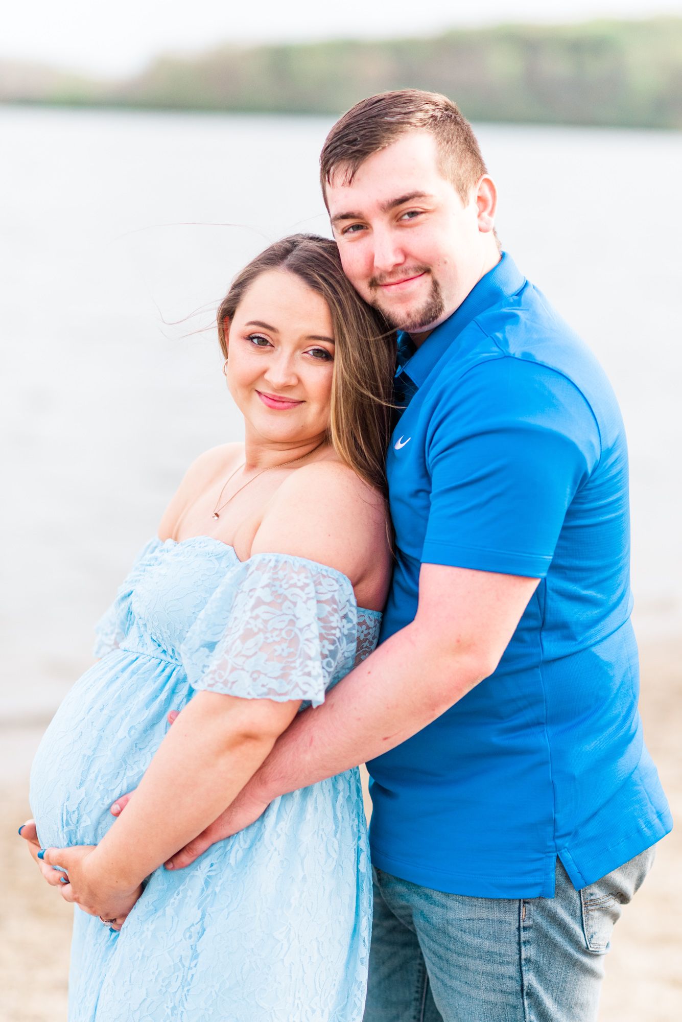 Maternity session with couple on beach in golden hour sunlight at Moraine State Park, Pennsylvania