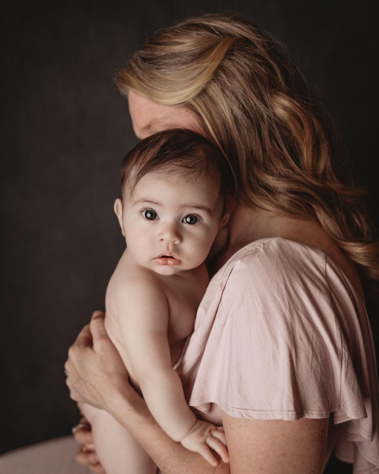 baby girl mom and daughter pink dress motherhood session snuggling mom and baby studio photography