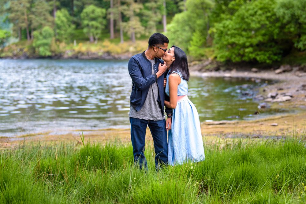 Young couple kissing beside Derwentwater in Lake District