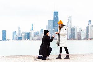 one woman on one knee proposing to girlfriend for Chicago proposal at North Avenue Beach
