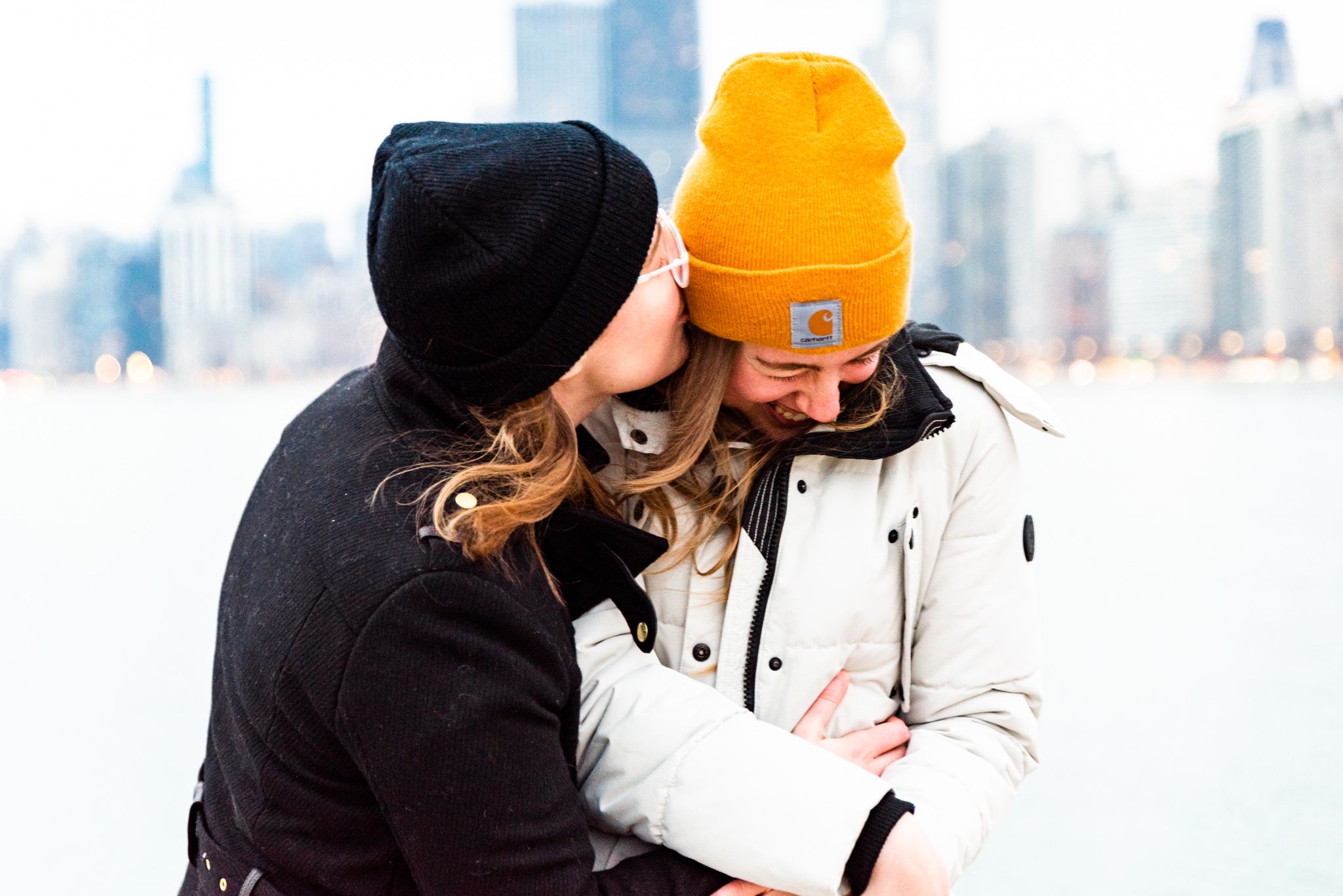 two women on pier at North Avenue Beach hugging and laughing